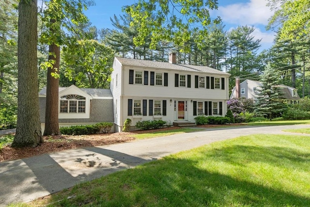 2 Pomfret Rd, Chelmsford, MA 01824 - colonial home featuring a chimney and a front lawn