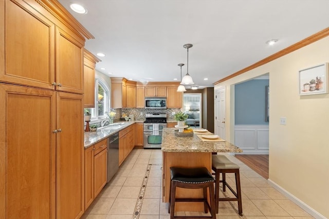 2 Pomfret Rd, Chelmsford, MA 01824 - kitchen featuring appliances with stainless steel finishes, a kitchen island, backsplash, light stone counters, and recessed lighting