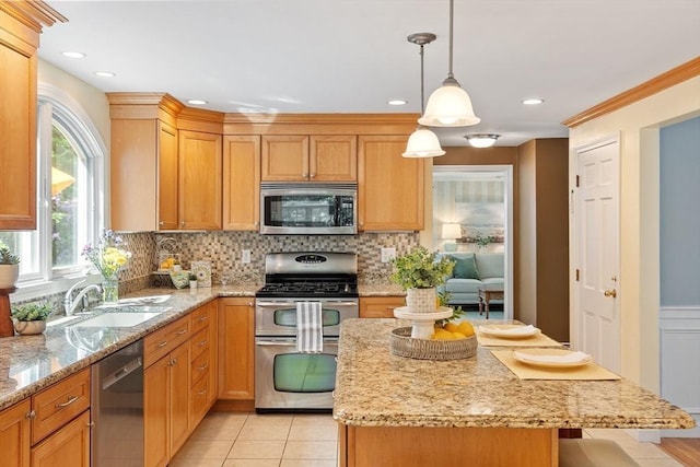 2 Pomfret Rd, Chelmsford, MA 01824 - kitchen featuring stainless steel appliances, tasteful backsplash, light stone countertops, a sink, and a center island