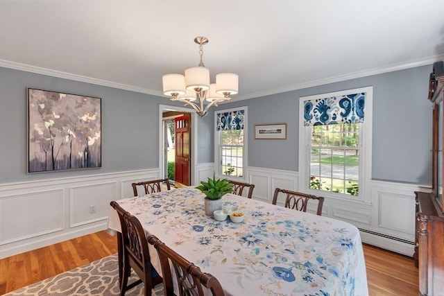 2 Pomfret Rd, Chelmsford, MA 01824 - dining room featuring a baseboard radiator, light wood-style flooring, a chandelier, crown molding, and wainscoting
