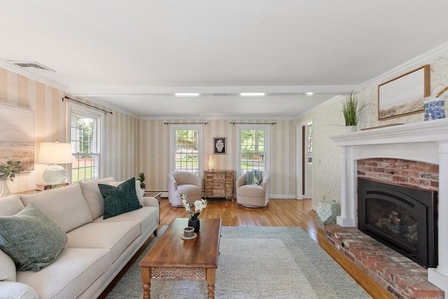 2 Pomfret Rd, Chelmsford, MA 01824 - living area with wallpapered walls, crown molding, wood finished floors, a fireplace, and baseboards