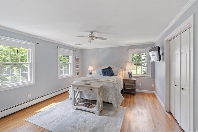 2 Pomfret Rd, Chelmsford, MA 01824 - bedroom featuring a baseboard heating unit, ornamental molding, light wood-style flooring, a closet, and ceiling fan