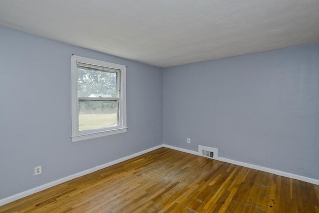 empty room with hardwood / wood-style floors