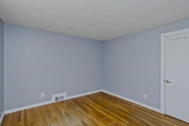 spare room featuring hardwood / wood-style flooring