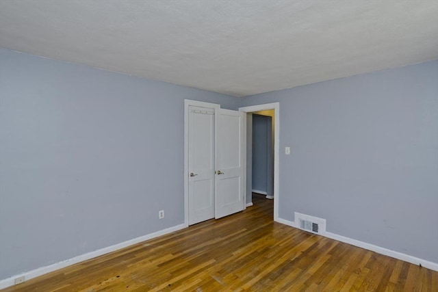 spare room with hardwood / wood-style floors