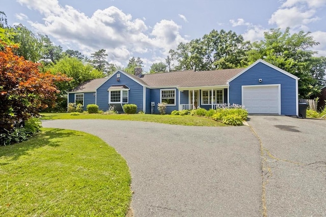 single story home with a garage and a front yard