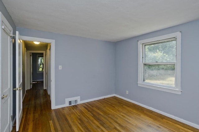 spare room with hardwood / wood-style floors