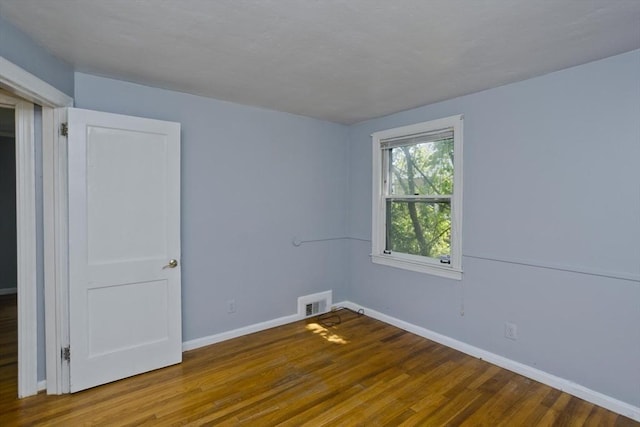 unfurnished room featuring wood-type flooring