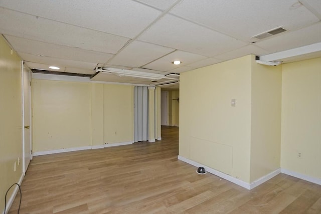 basement featuring wood-type flooring and a drop ceiling