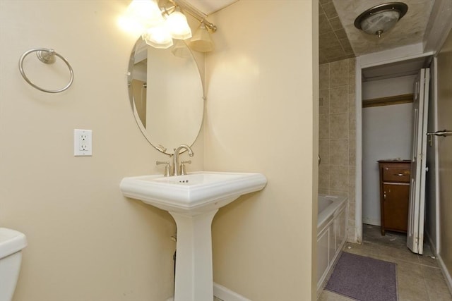 bathroom with tile patterned floors and toilet