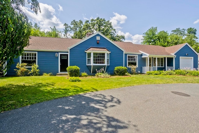 ranch-style house with a garage and a front lawn