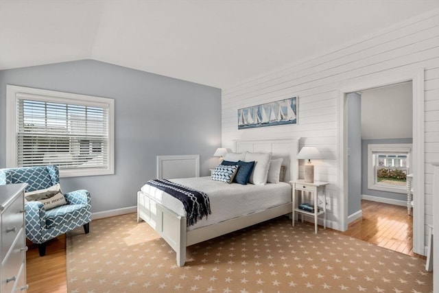 21 Glenwood St, Yarmouth, MA 02673 - bedroom with vaulted ceiling, wood finished floors, multiple windows, and wooden walls
