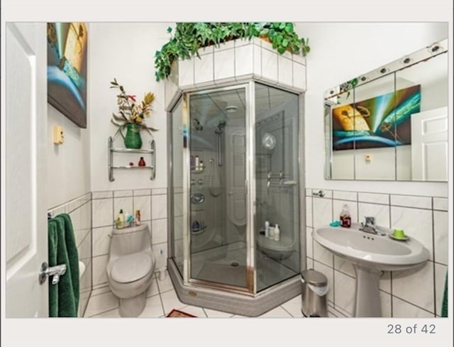 1820 Bay St, Taunton, MA 02780 - bathroom with tile walls, tile patterned floors, a shower stall, toilet, and a wainscoted wall