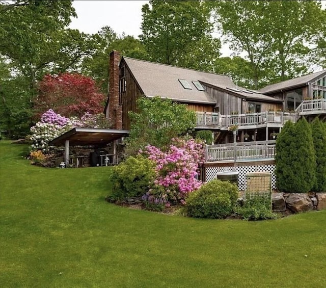 1820 Bay St, Taunton, MA 02780 - rear view of house with a chimney, a lawn, and a wooden deck