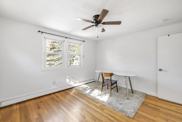 office with ceiling fan, a baseboard radiator, wood finished floors, and baseboards