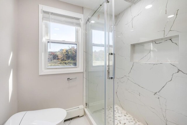 bathroom with marble finish floor, baseboard heating, a marble finish shower, and toilet