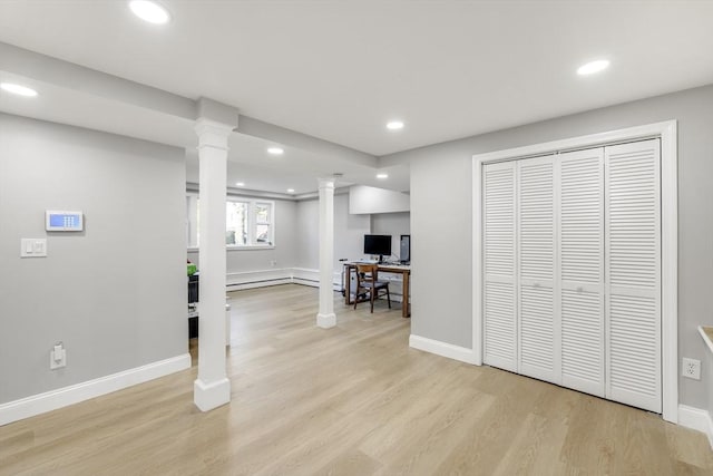 basement featuring light wood-style floors, recessed lighting, and baseboards