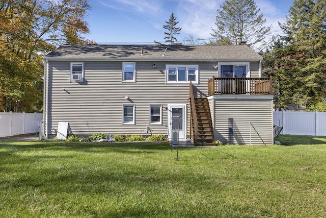 back of property with stairs, a lawn, fence, and a wooden deck