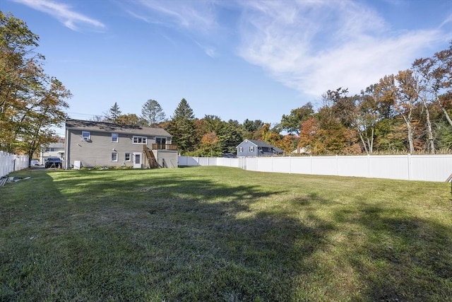 view of yard with stairway and a fenced backyard