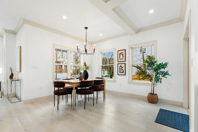 dining area featuring light hardwood / wood-style floors, ornamental molding, and an inviting chandelier