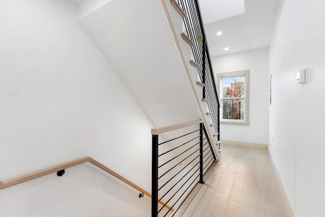 staircase with hardwood / wood-style flooring