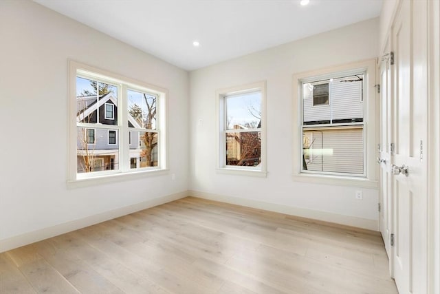 spare room featuring light hardwood / wood-style floors