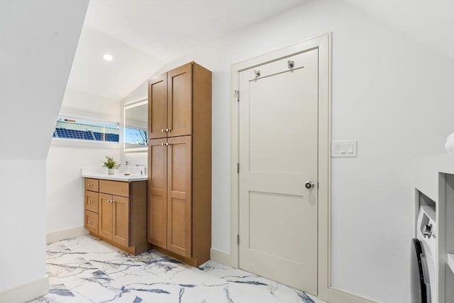 bathroom with vanity and lofted ceiling