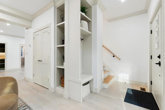 mudroom with crown molding and light hardwood / wood-style floors