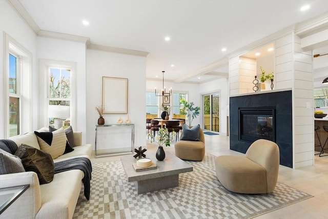 living room with an inviting chandelier and ornamental molding