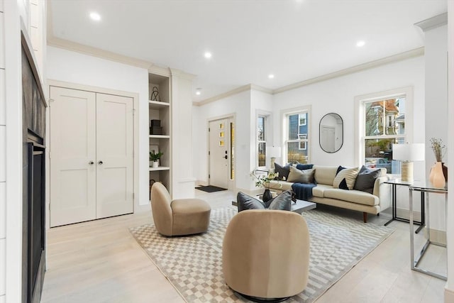 living room featuring light hardwood / wood-style flooring and ornamental molding