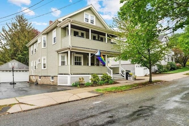 29 Daniels St Unit 29, Arlington, MA 02476 - view of front of house with a porch, an outdoor structure, a garage, a balcony, and a chimney