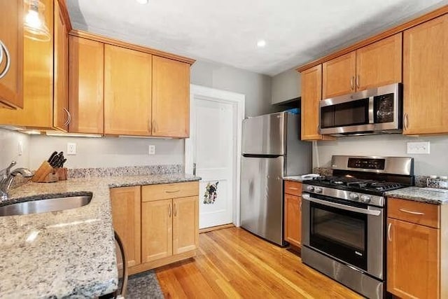 29 Daniels St Unit 29, Arlington, MA 02476 - kitchen with appliances with stainless steel finishes, light wood-style flooring, a sink, light stone counters, and recessed lighting