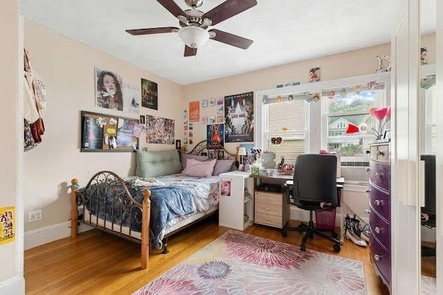 29 Daniels St Unit 29, Arlington, MA 02476 - bedroom with wood finished floors, a desk, a ceiling fan, and baseboards