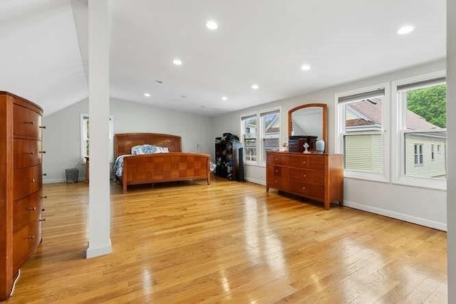 29 Daniels St Unit 29, Arlington, MA 02476 - bedroom with multiple windows, vaulted ceiling, light wood finished floors, recessed lighting, and baseboards