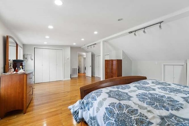 29 Daniels St Unit 29, Arlington, MA 02476 - bedroom with light wood-type flooring, recessed lighting, rail lighting, and vaulted ceiling