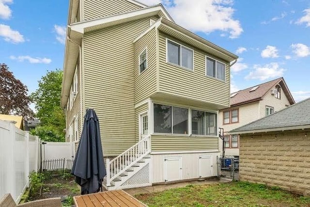 29 Daniels St Unit 29, Arlington, MA 02476 - back of house with fence, stairway, and a sunroom