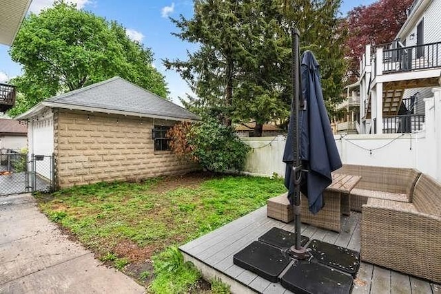 29 Daniels St Unit 29, Arlington, MA 02476 - fenced backyard featuring a deck, a gate, and an outdoor hangout area