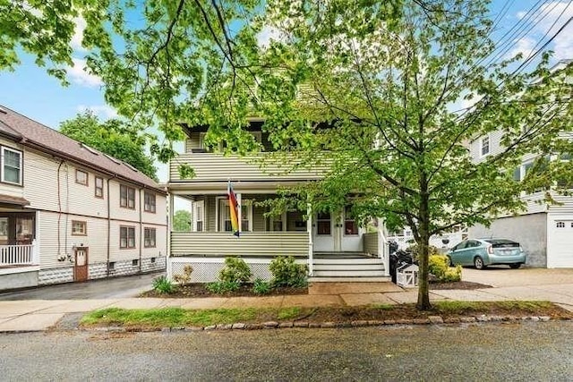 29 Daniels St Unit 29, Arlington, MA 02476 - view of front of house featuring covered porch and driveway