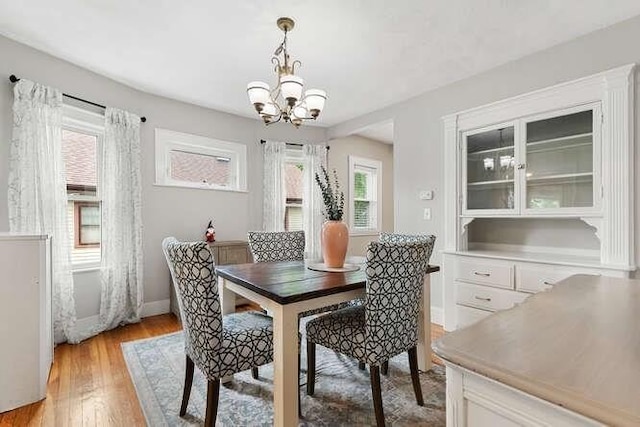 29 Daniels St Unit 29, Arlington, MA 02476 - dining space featuring a chandelier, light wood-type flooring, and baseboards