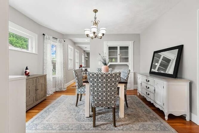 29 Daniels St Unit 29, Arlington, MA 02476 - dining space featuring a chandelier, wood finished floors, and baseboards