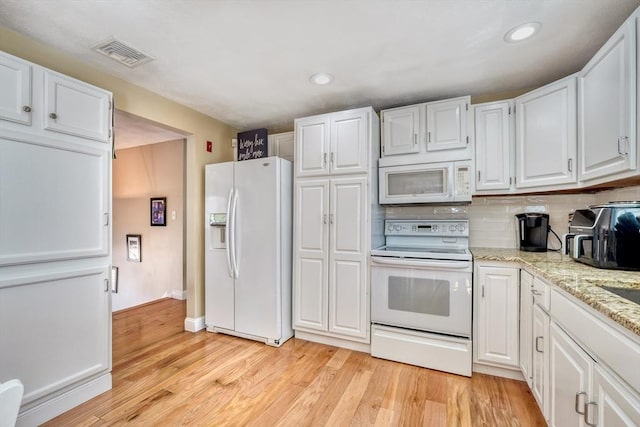 kitchen featuring visible vents, backsplash, white cabinetry, white appliances, and light wood-style floors