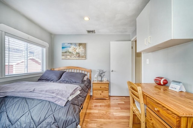 bedroom featuring visible vents and light wood-type flooring