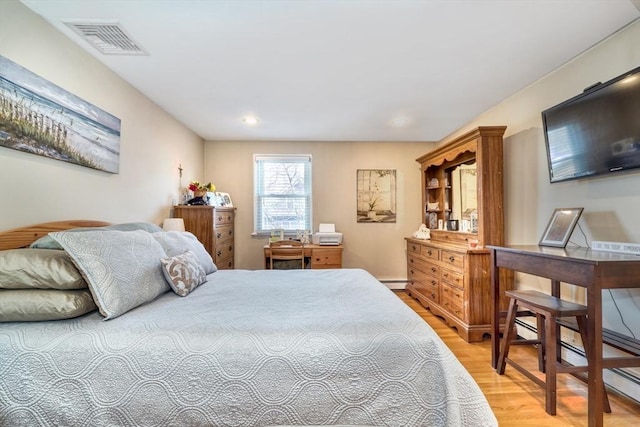 bedroom with recessed lighting, visible vents, light wood-style floors, and baseboard heating