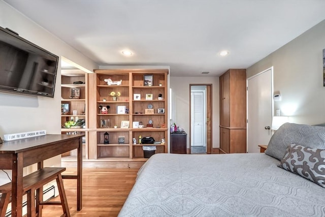 bedroom with recessed lighting and light wood-type flooring