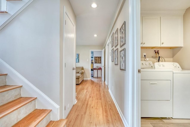 laundry area featuring washing machine and dryer, recessed lighting, cabinet space, light wood finished floors, and baseboards