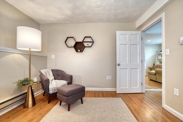 living area featuring light wood-style flooring and baseboards