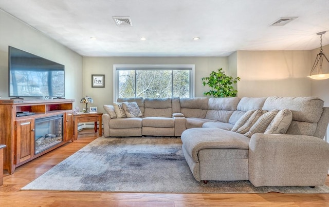 living room featuring recessed lighting, visible vents, and light wood finished floors