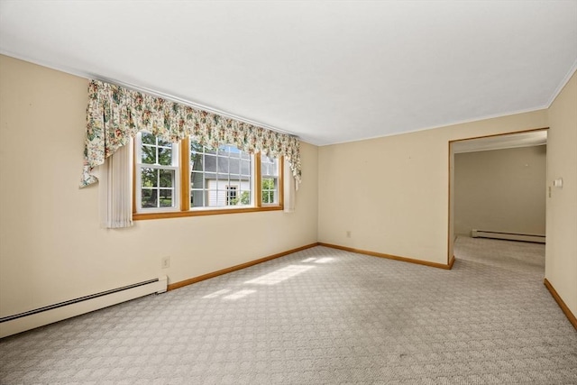 spare room with a baseboard heating unit, baseboards, carpet flooring, and ornamental molding
