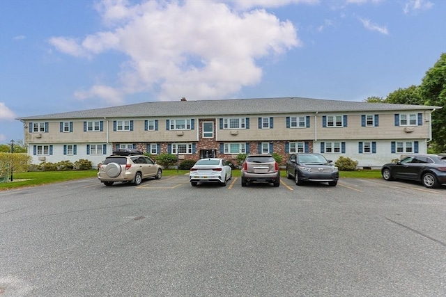 view of building exterior with uncovered parking