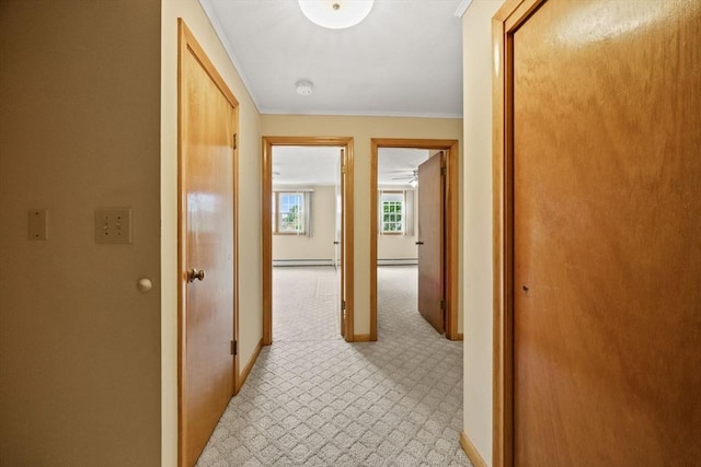 hallway with baseboards, ornamental molding, and a baseboard radiator